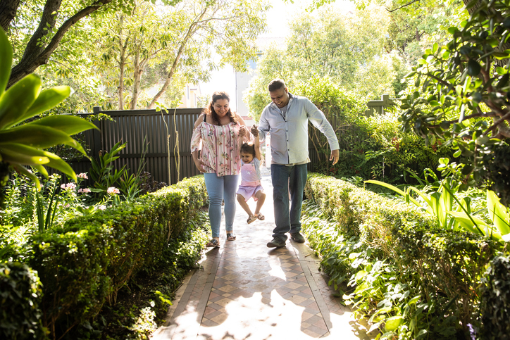 mum-and-dad-arriving-home-and-lifting-up-little-girl