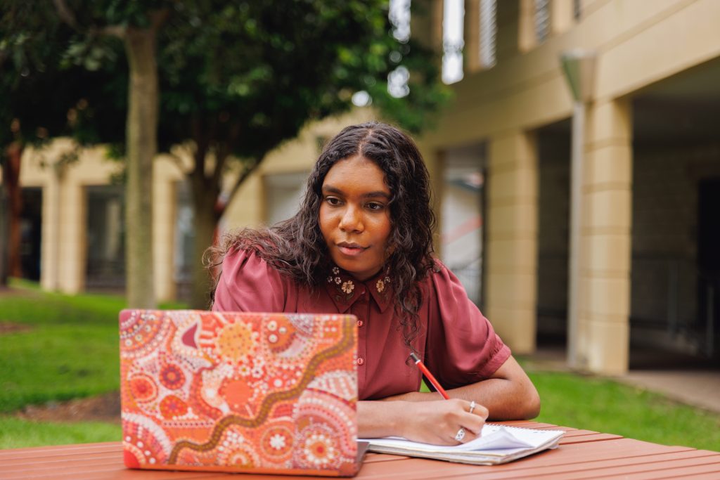 female-aboriginal-australian-student-working-on-laptop